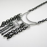 grey pendant with black chain fringe