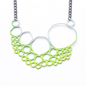 neon green to grey ombre gradation on circle necklace